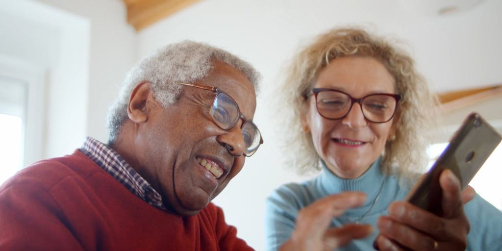 happy couple using a dating app on their smartphones