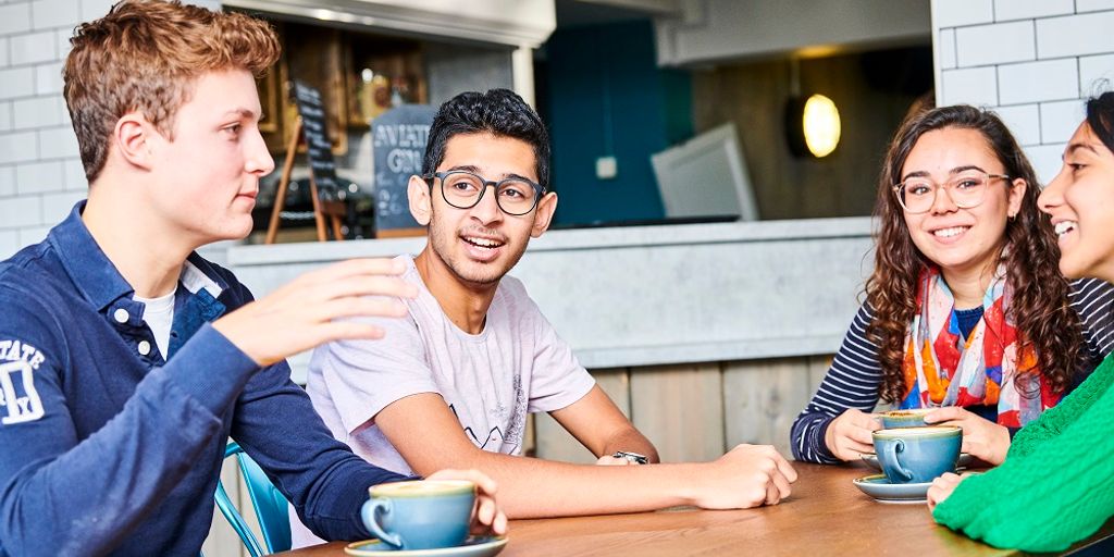 two people chatting happily in a cozy cafe